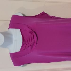 Fuchsia blouse made from polyester and spandex.